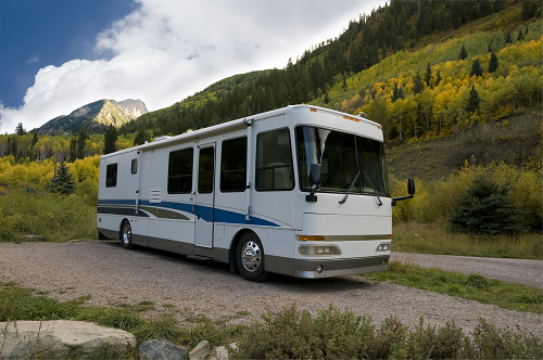 a bus driving down a dirt road